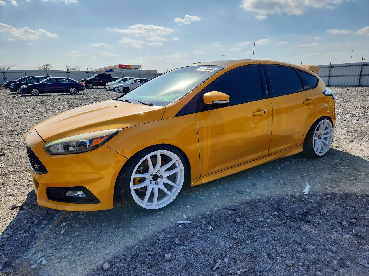 2015 Ford Focus ST, VIN 1FADP3L9XFL216203 — Side