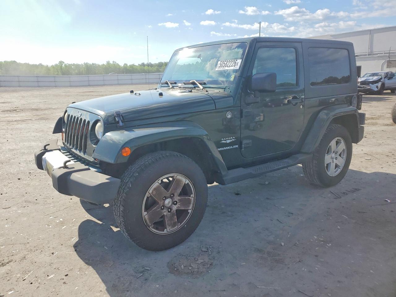 2010 Jeep Wrangler Sahara, VIN 1J4AA5D13AL124906 — Side
