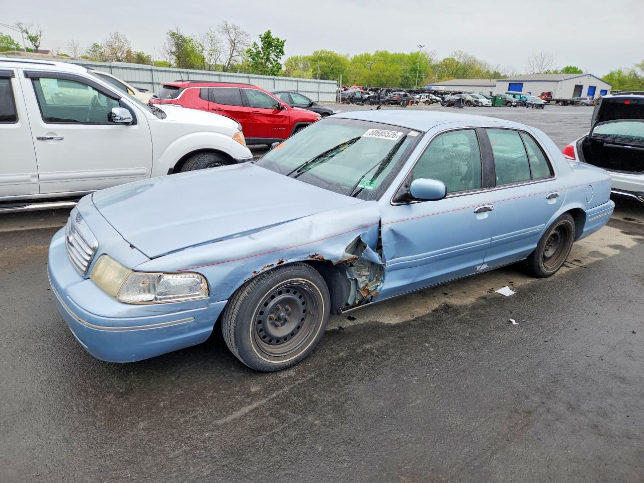 2000 Ford Crown Victoria, VIN 2FAFP73W7YX135963 — Side
