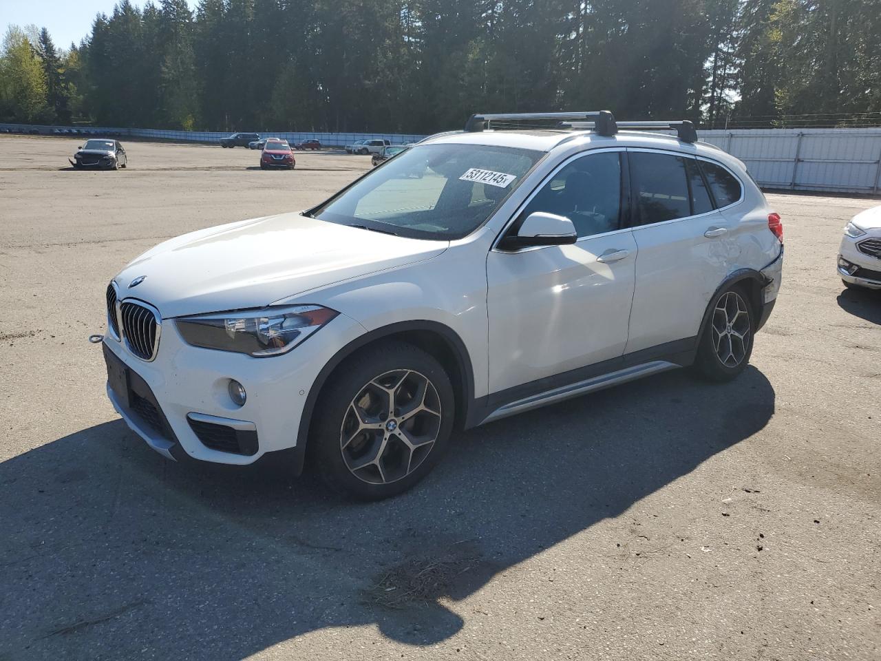 2018 BMW X1 xDrive28i, VIN WBXHT3C35J5L28748 — Auction photo