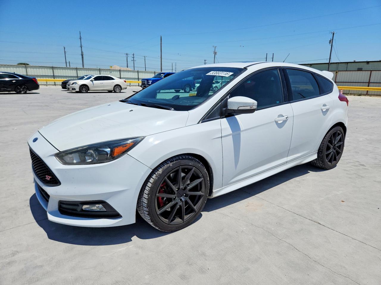 2015 Ford Focus ST, VIN 1FADP3L90FL334132 — Side
