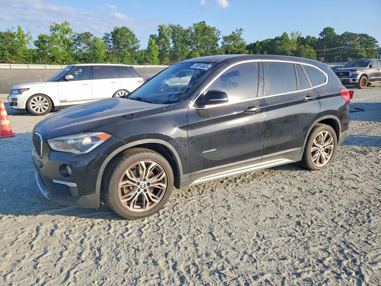 2018 BMW X1 xDrive28i, VIN WBXHT3C34J5F92921 — Minor dents and scratches