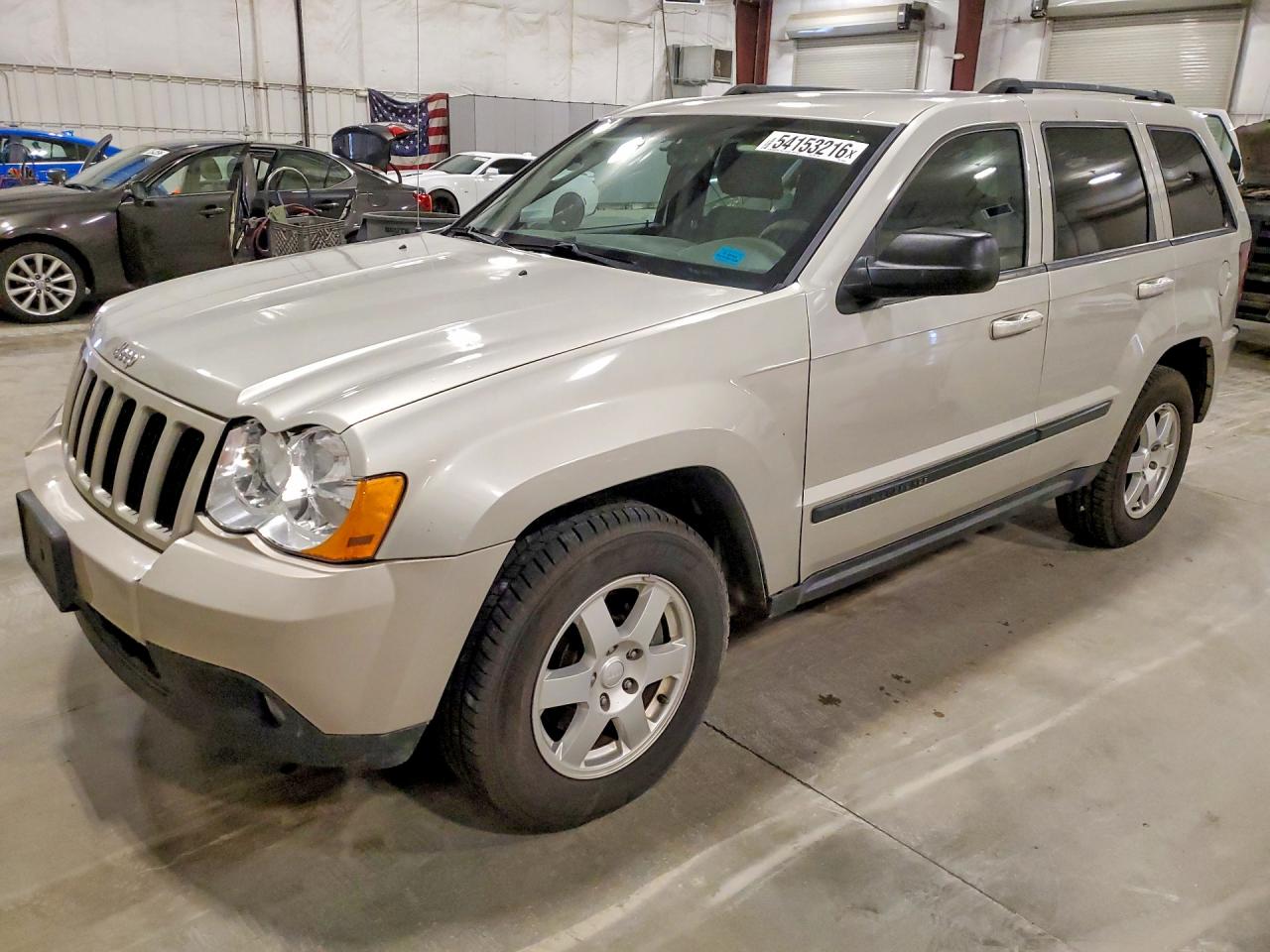 2009 Jeep Grand Cherokee Laredo, VIN 1J8HR48P49C552638 — Side