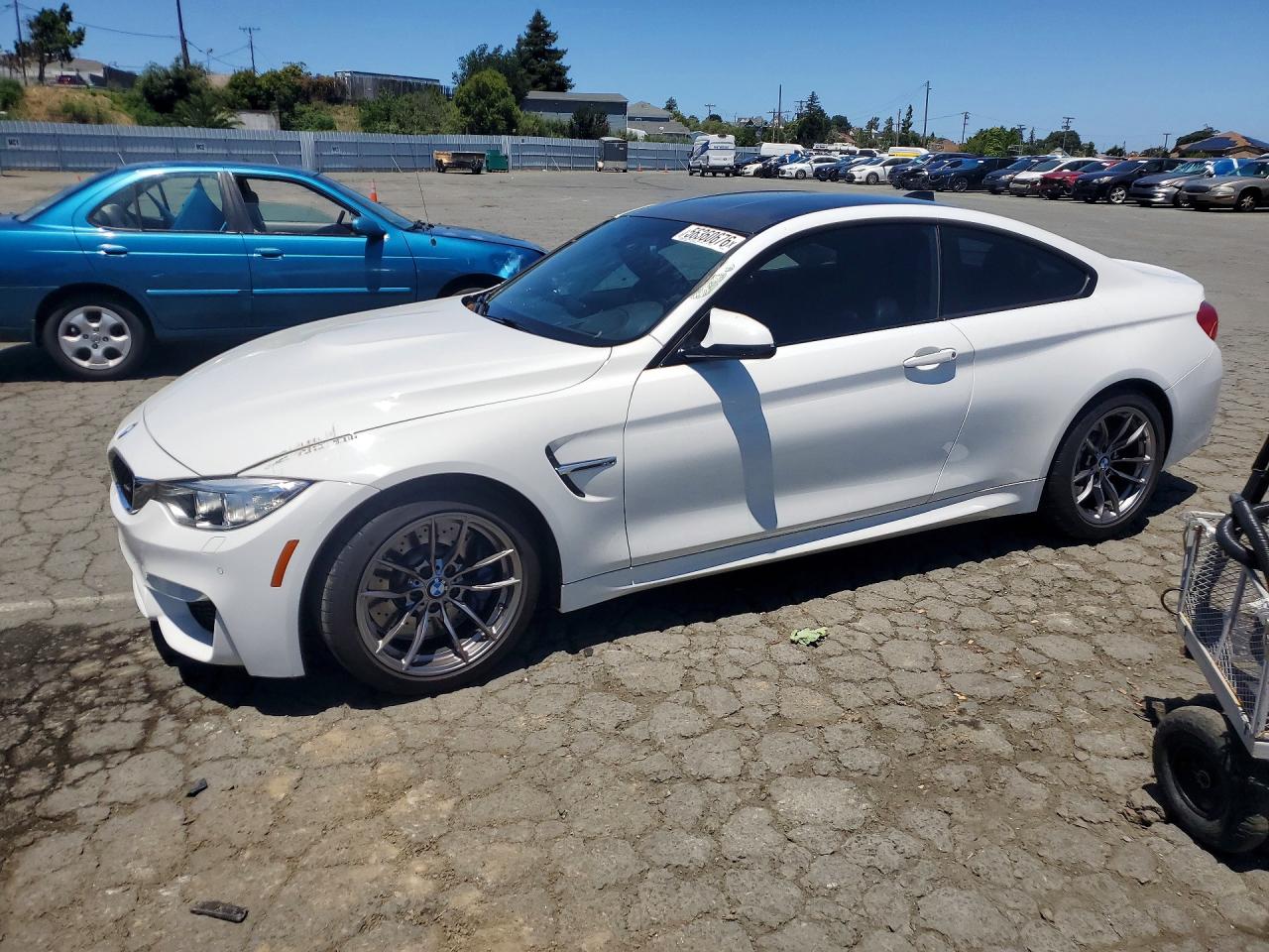 2015 BMW M4, VIN WBS3R9C58FK330070 — Side