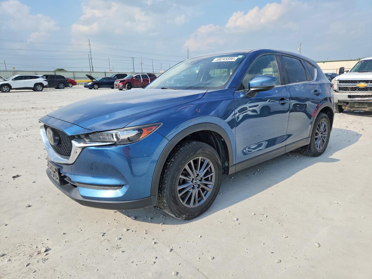 2019 Mazda CX-5 Touring, VIN JM3KFACM1K1576292 — Бок