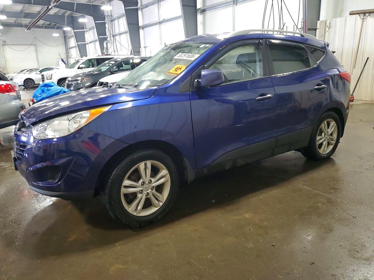 2011 Hyundai Tucson Limited, VIN KM8JU3AC4BU136657 — Side