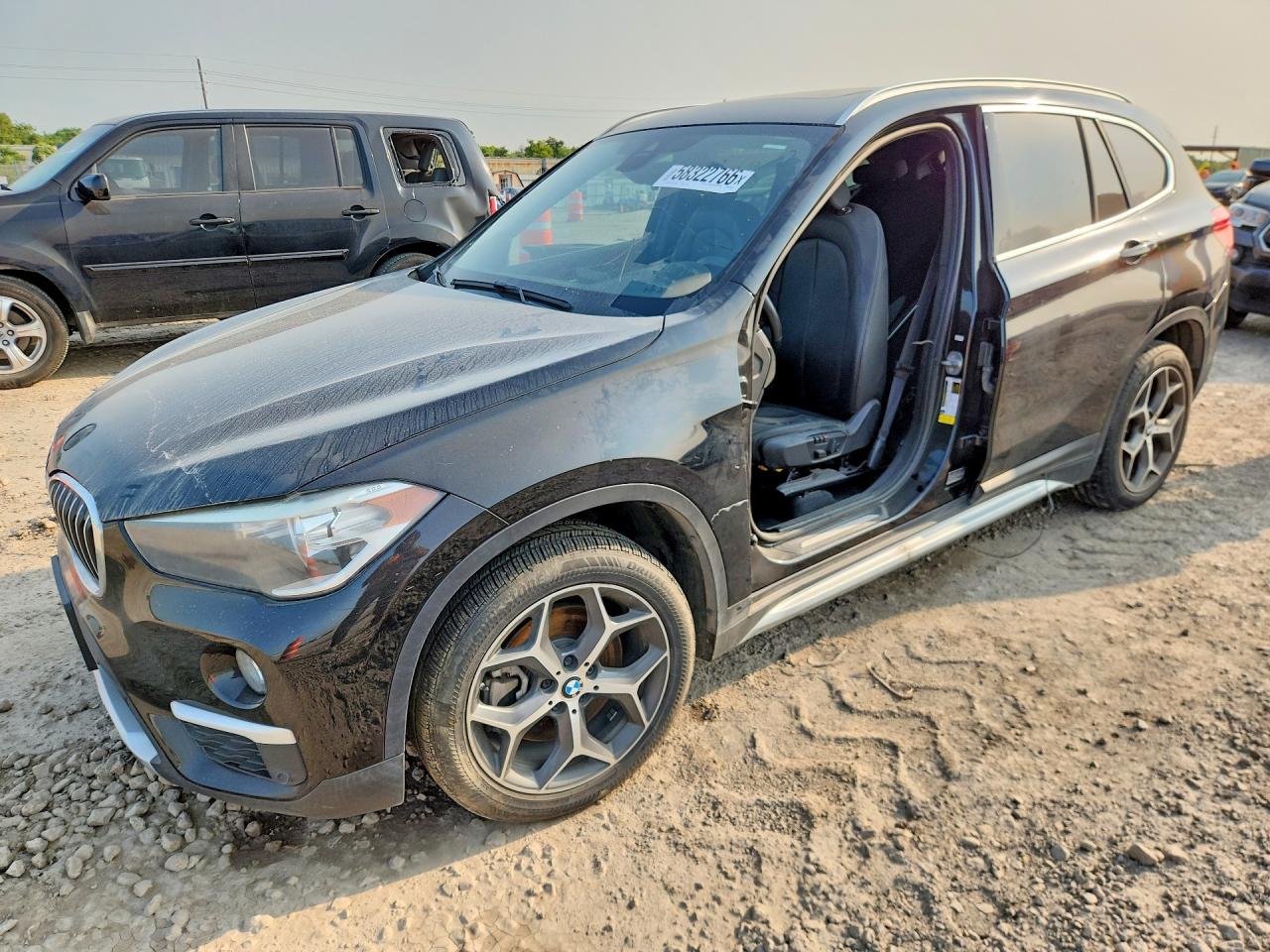 2019 BMW X1 sDrive28i, VIN WBXHU7C58K3H45075 — Side