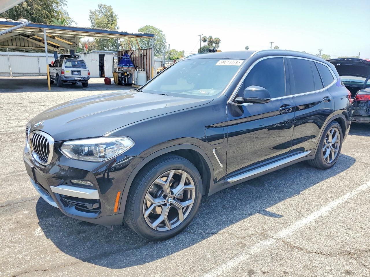 2021 BMW X3 xDrive30e, VIN 5UXTS1C05M9G31824 — Side