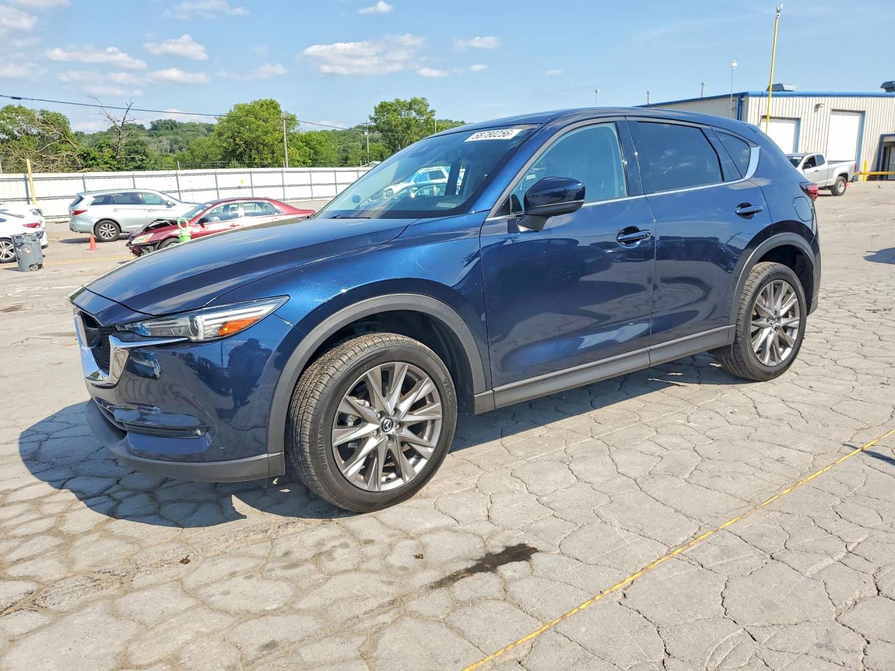 2021 Mazda CX-5 Grand Touring, VIN JM3KFBDM4M0489113 — Side