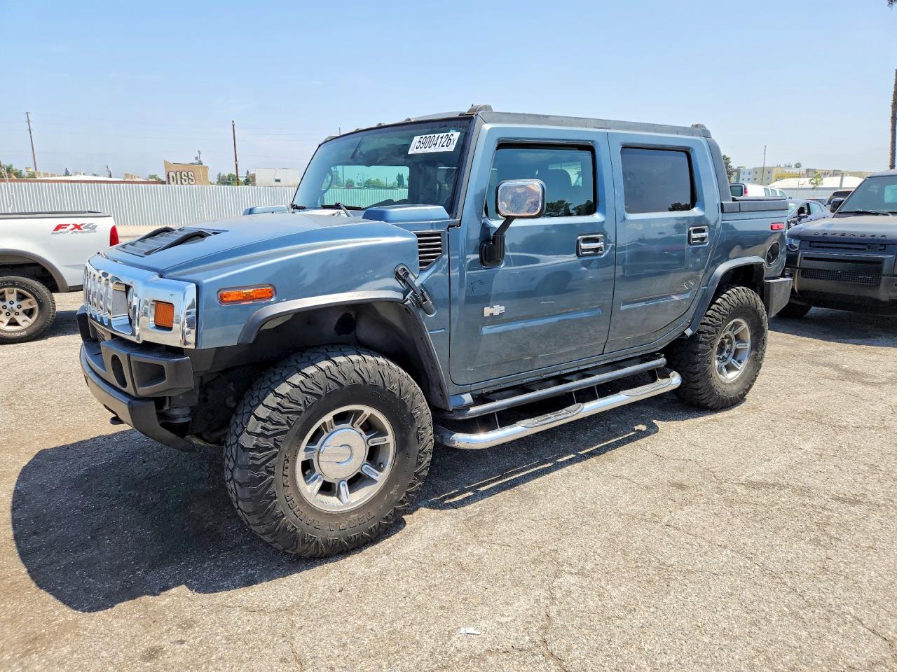 2005 Hummer H2 SUT, VIN 5GRGN22U95H115893 — Side