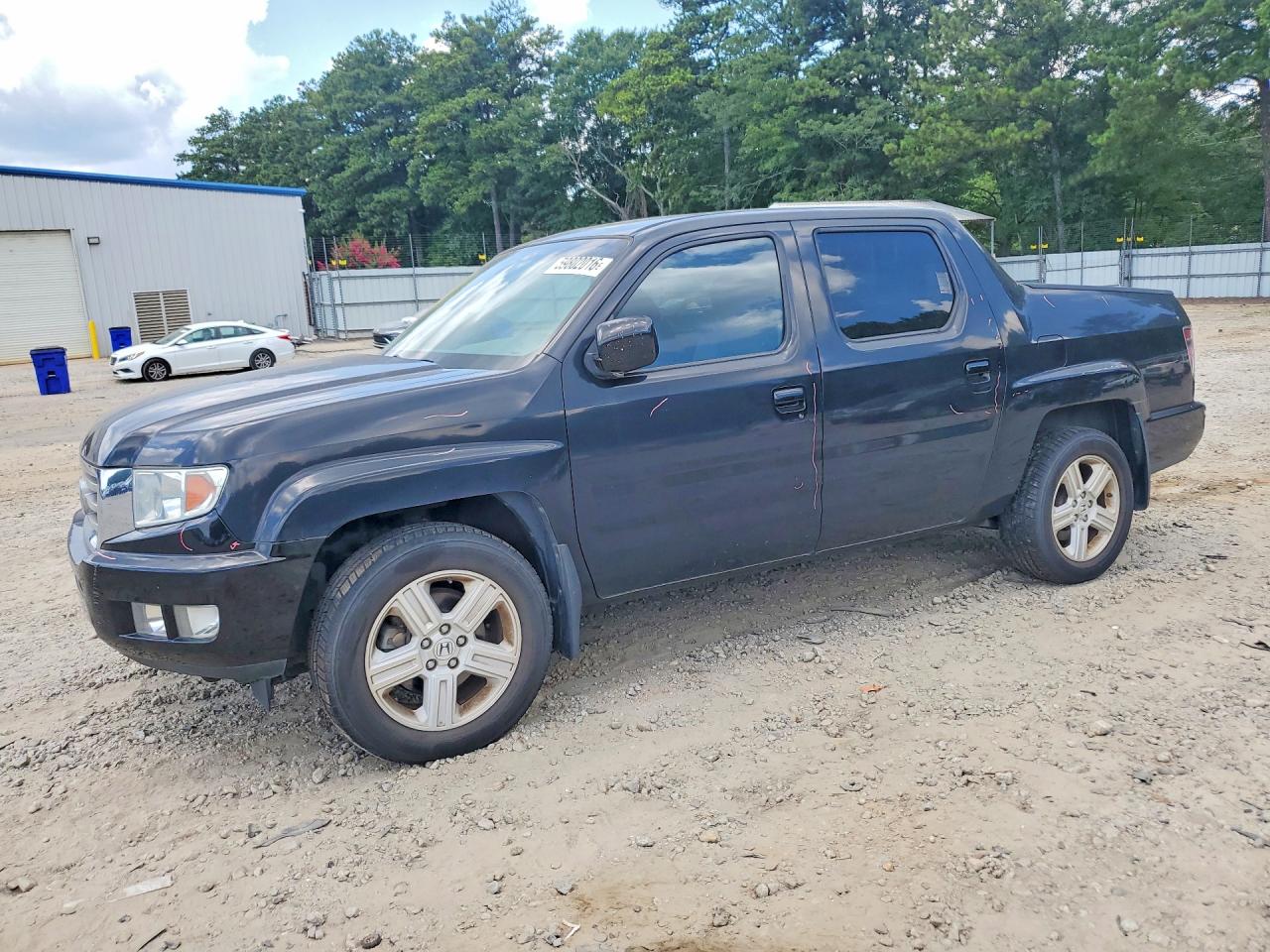 2012 Honda Ridgeline RTL, VIN 5FPYK1F52CB002903 — Side