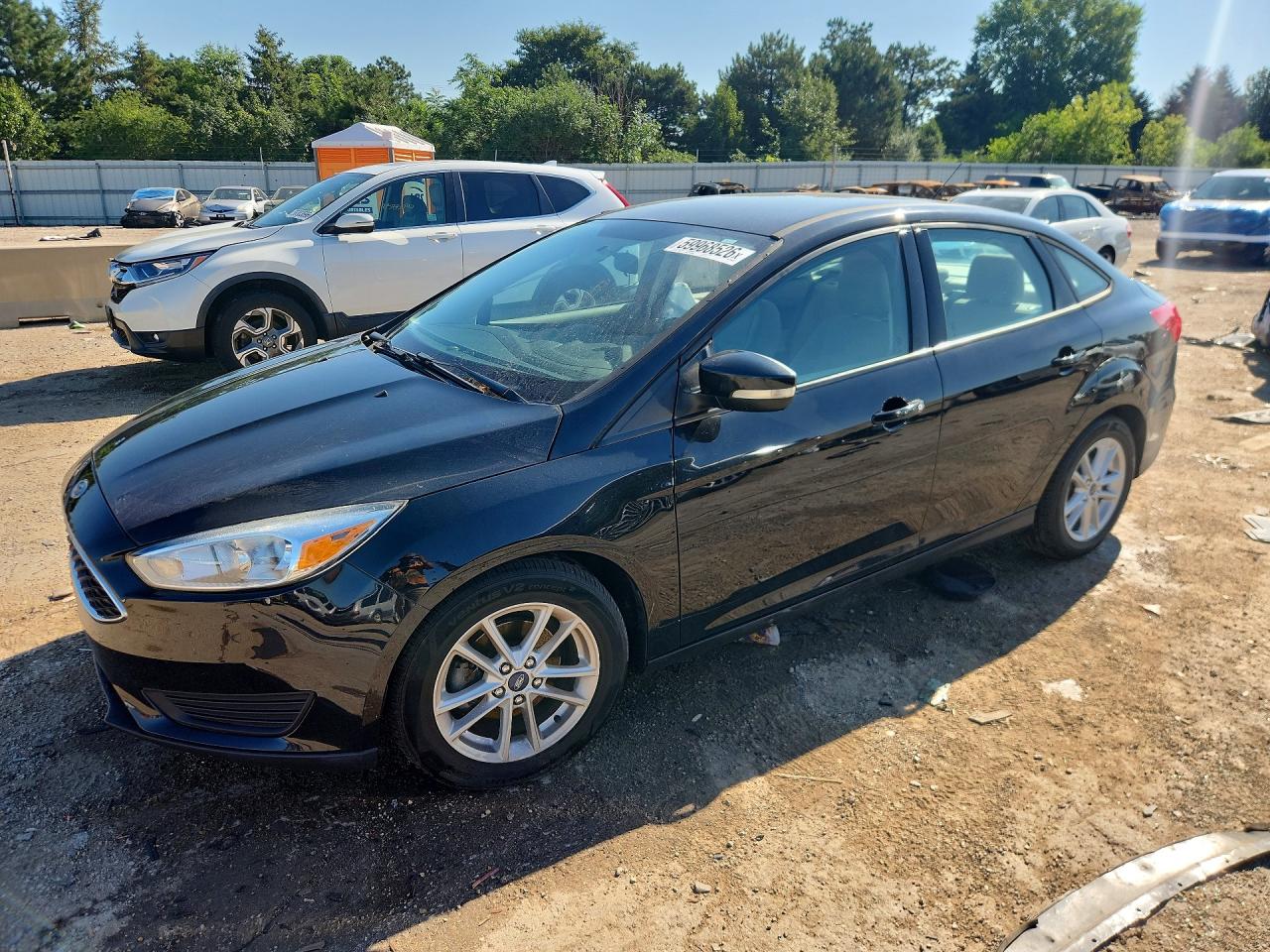 2015 Ford Focus SE, VIN 1FADP3F26FL361852 — Side