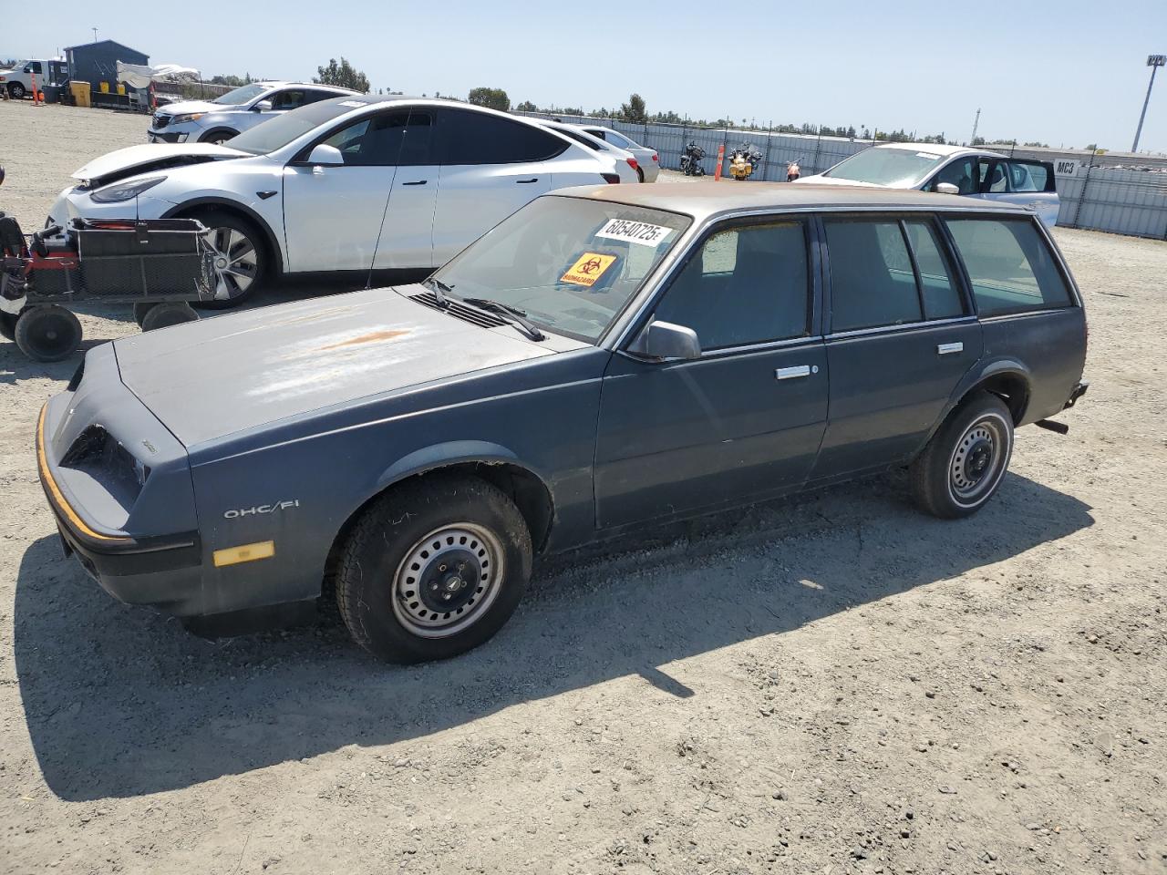 1985 Pontiac Sunbird, VIN 1G2JB350XF7575719 — Minor dents and scratches
