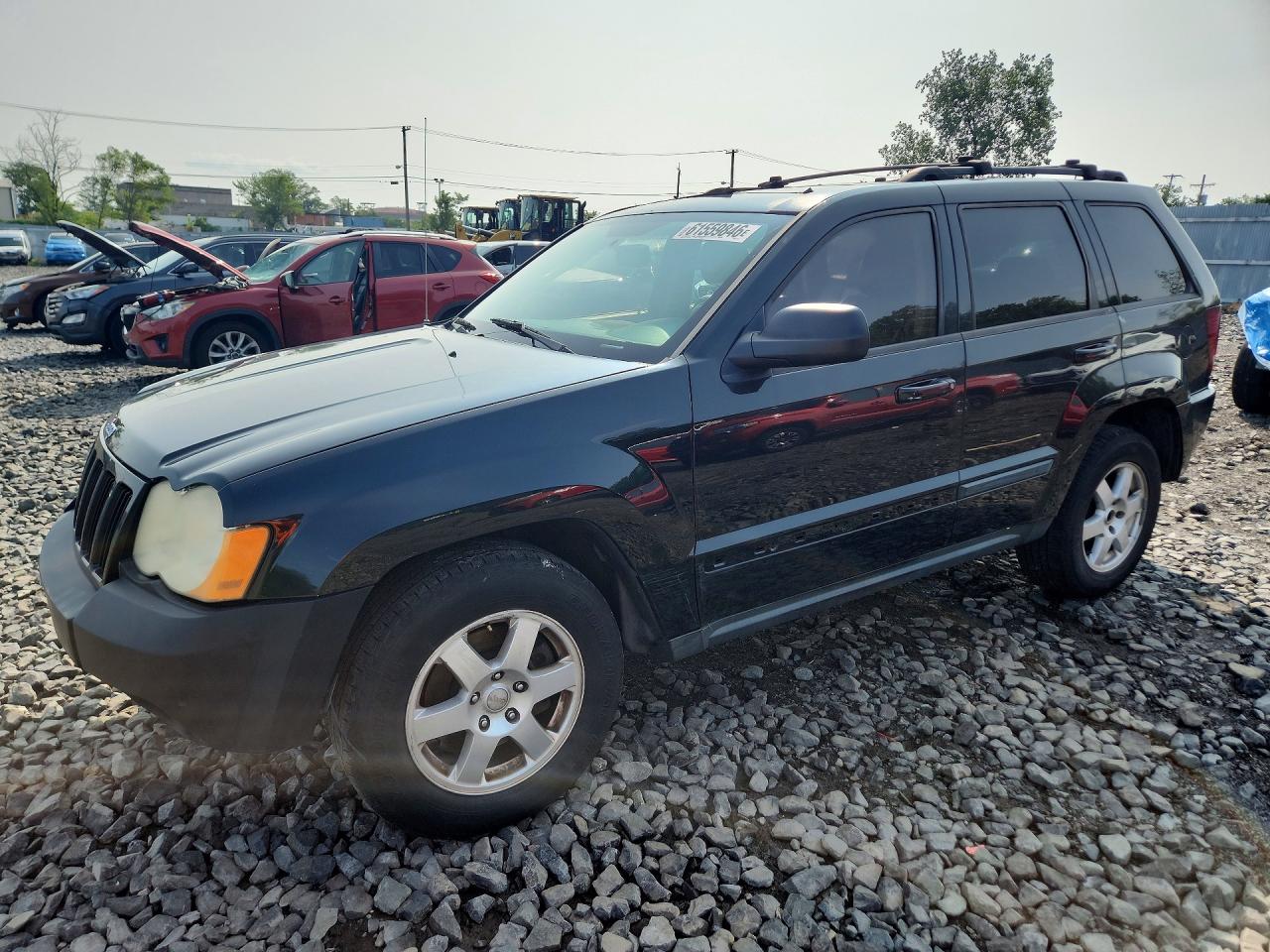 2009 Jeep Grand Cherokee Laredo, VIN 1J8GR48K49C519722 — Side