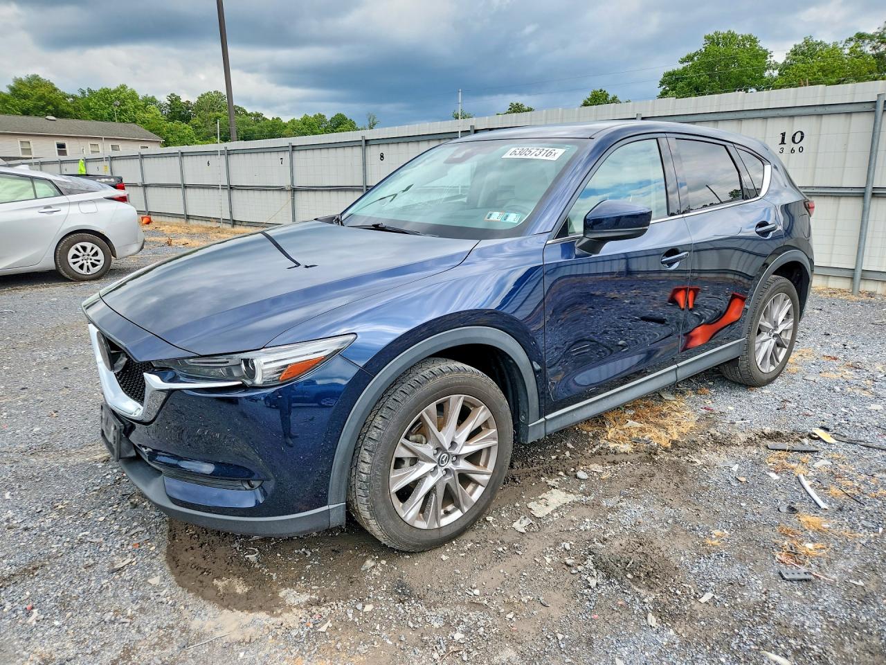2021 Mazda CX-5 Grand Touring, VIN JM3KFBDM7M1396337 — Side