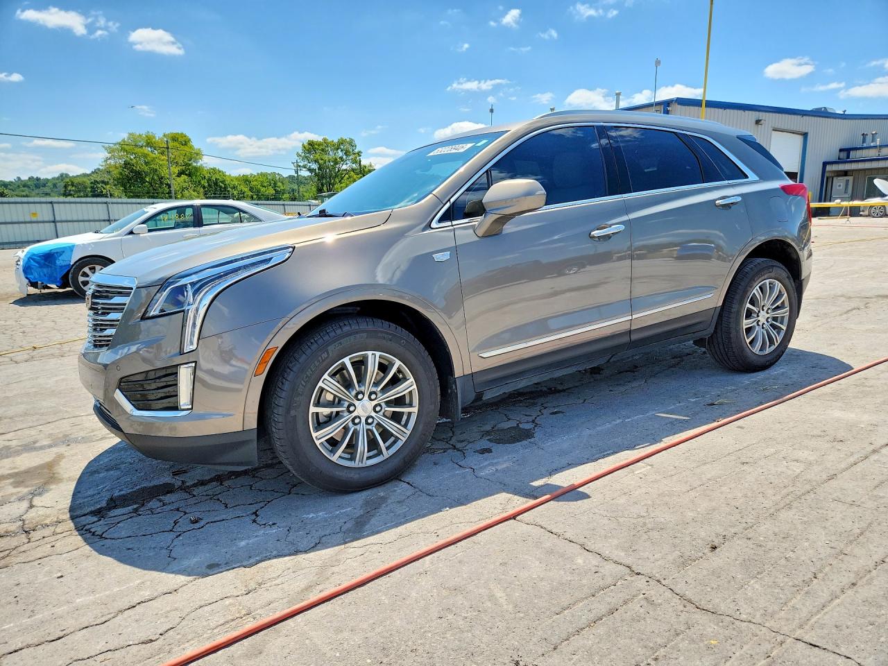 2019 Cadillac XT5 Luxury FWD, VIN 1GYKNCRS1KZ160607 — Side