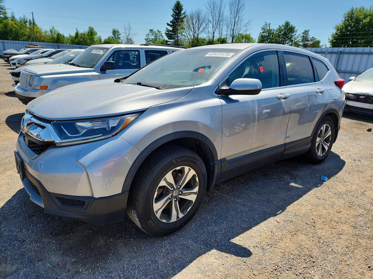 2019 Honda CR-V LX, VIN 2HKRW2H21KH143570 — Бок