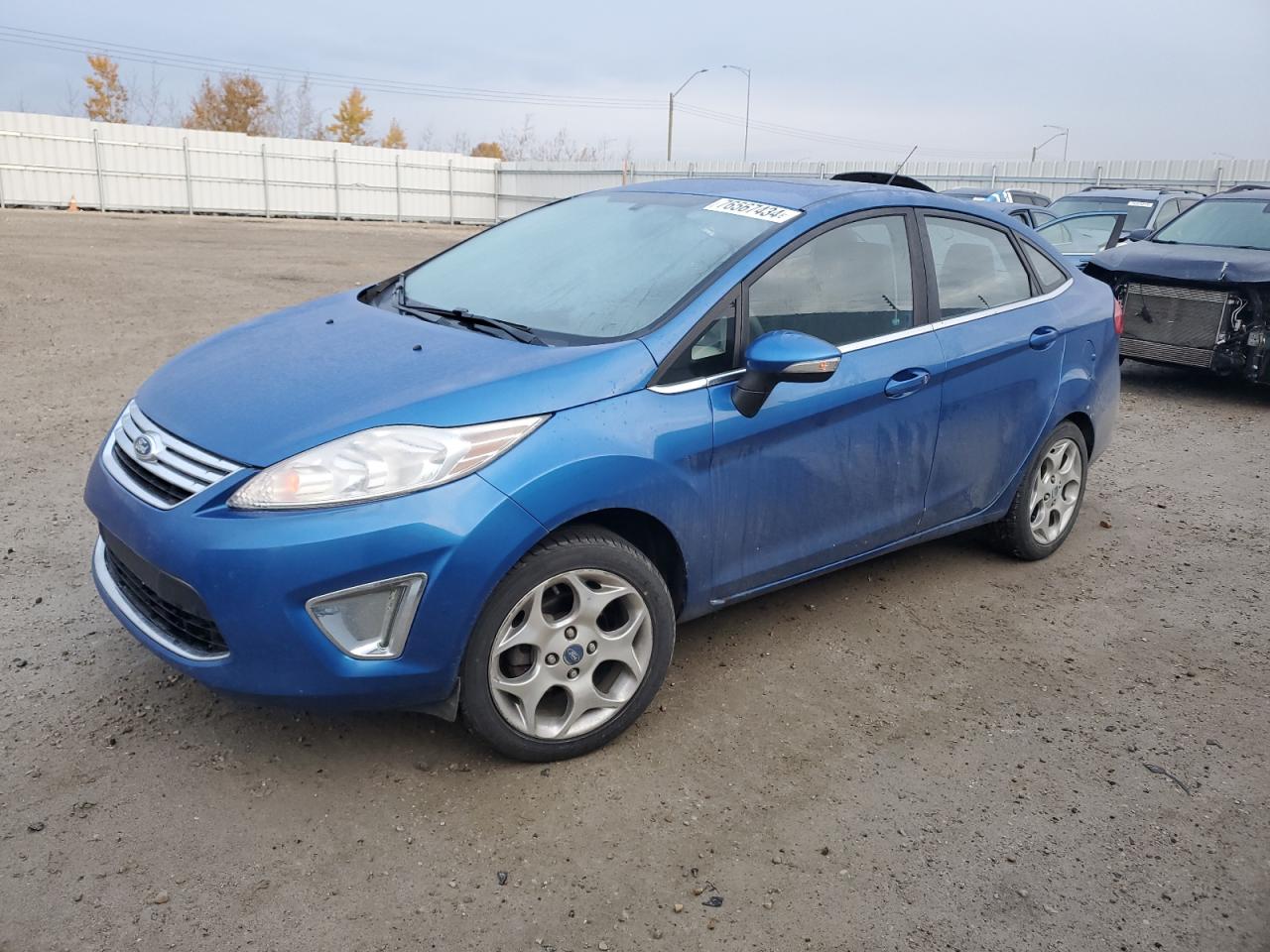 2011 Ford Fiesta SEL, VIN 3FADP4CJ4BM224774 — Side