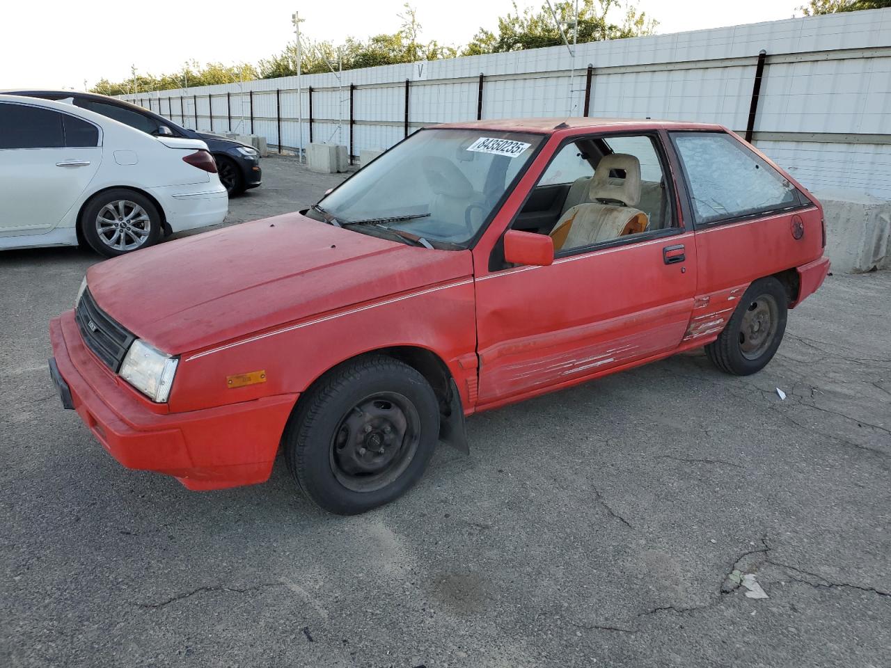 1988 Dodge Colt, VIN JB3BA34K9JU080994 — Side