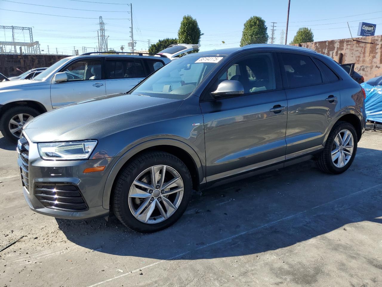 2018 Audi Q3 Premium, VIN WA1BCCFS4JR010659 — Side