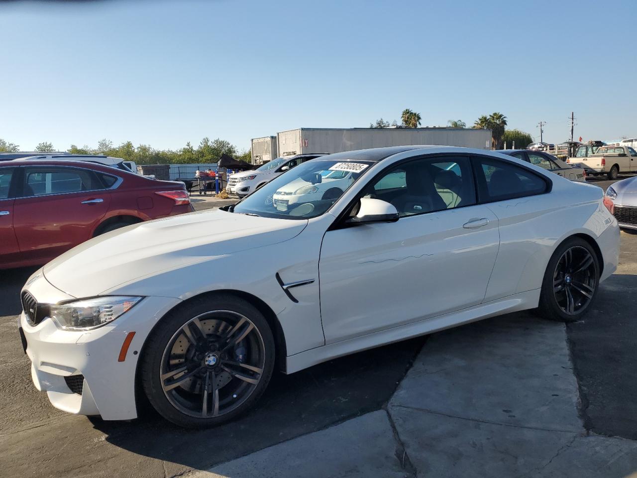 2016 BMW M4, VIN WBS3R9C5XGK338382 — Side