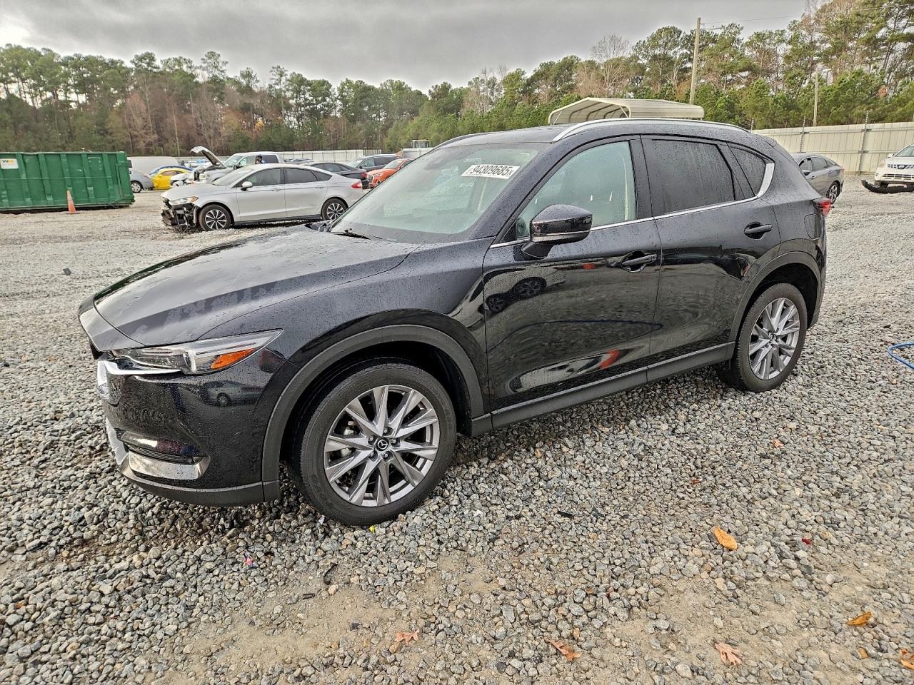 2021 Mazda CX-5 Grand Touring, VIN JM3KFBDM2M1447372 — Side