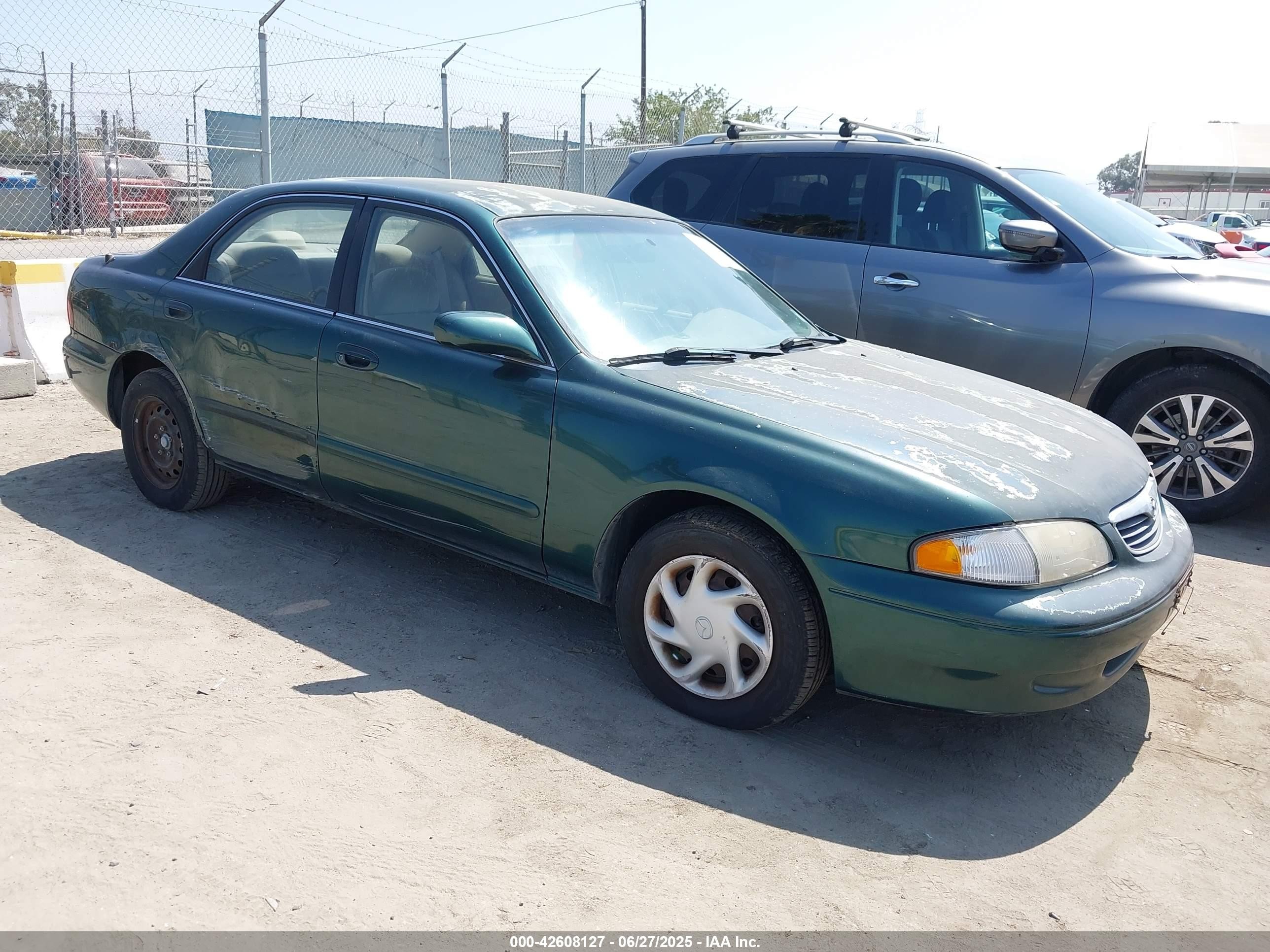 1998 Mazda 626 DX, VIN 1YVGF22C2W5721362 — Side