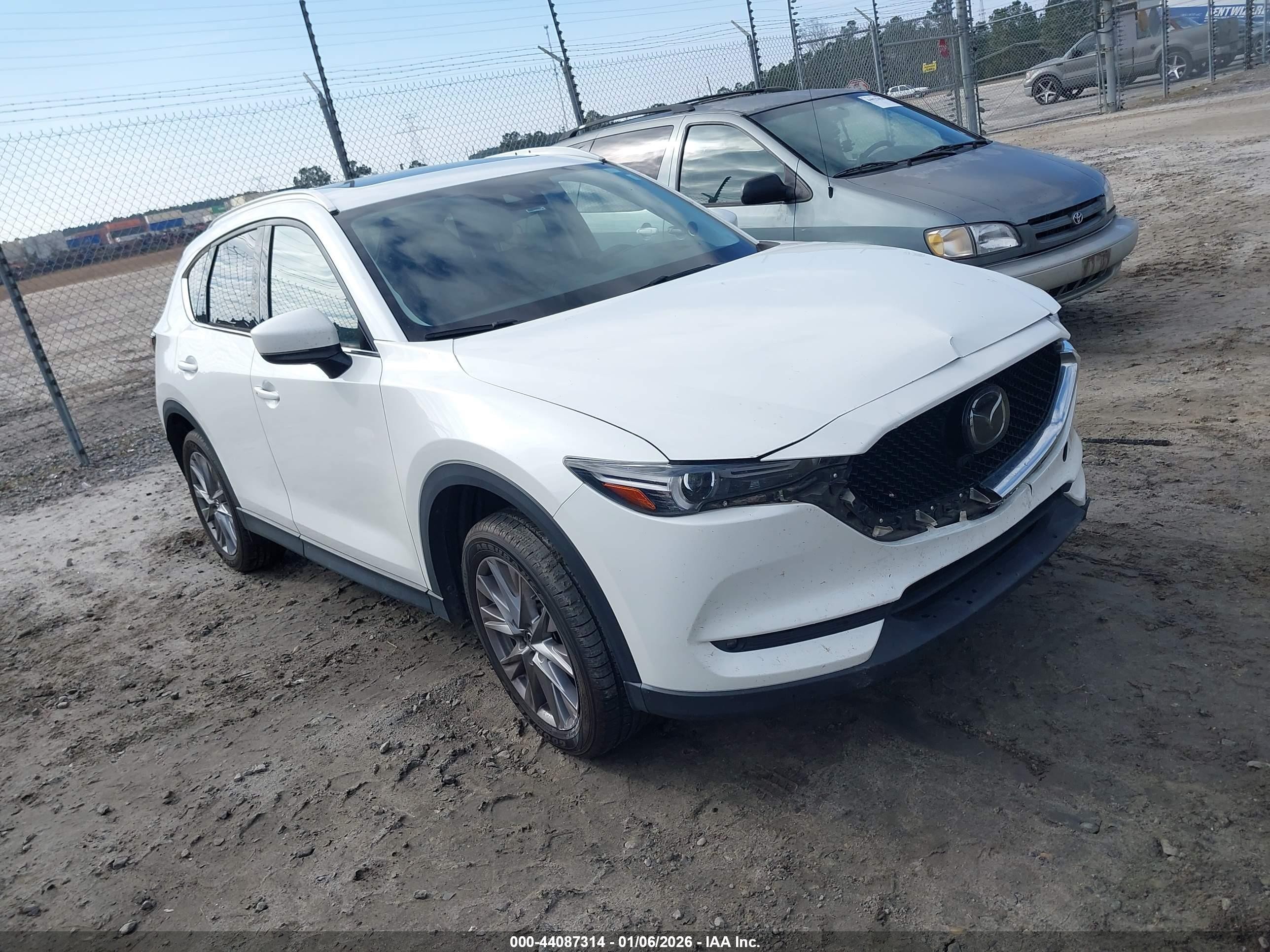 2021 Mazda CX-5 Grand Touring, VIN JM3KFADM2M0470019 — Side