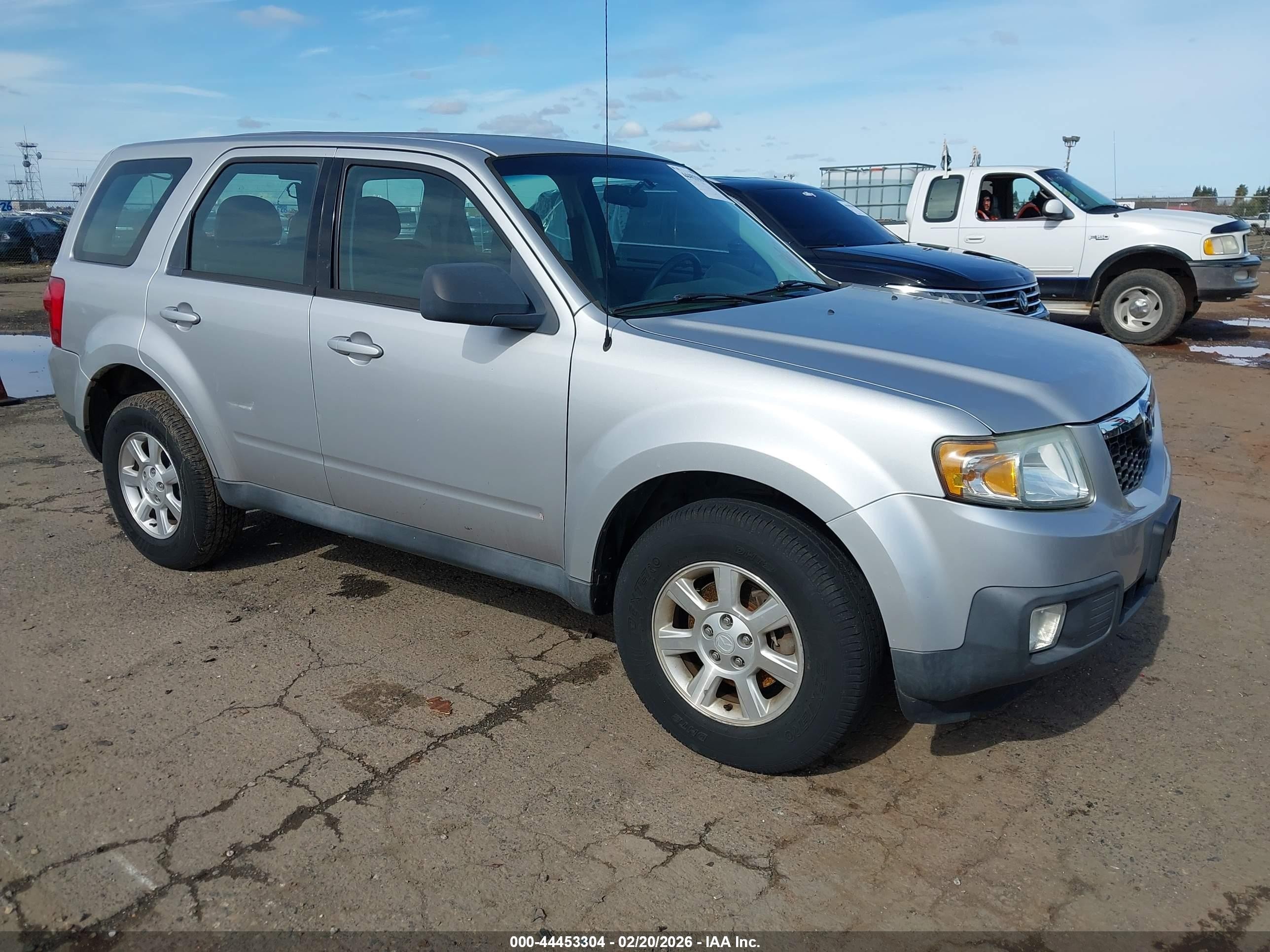 2010 Mazda Tribute Sport, VIN 4F2CY0C77AKM03879 — Бок