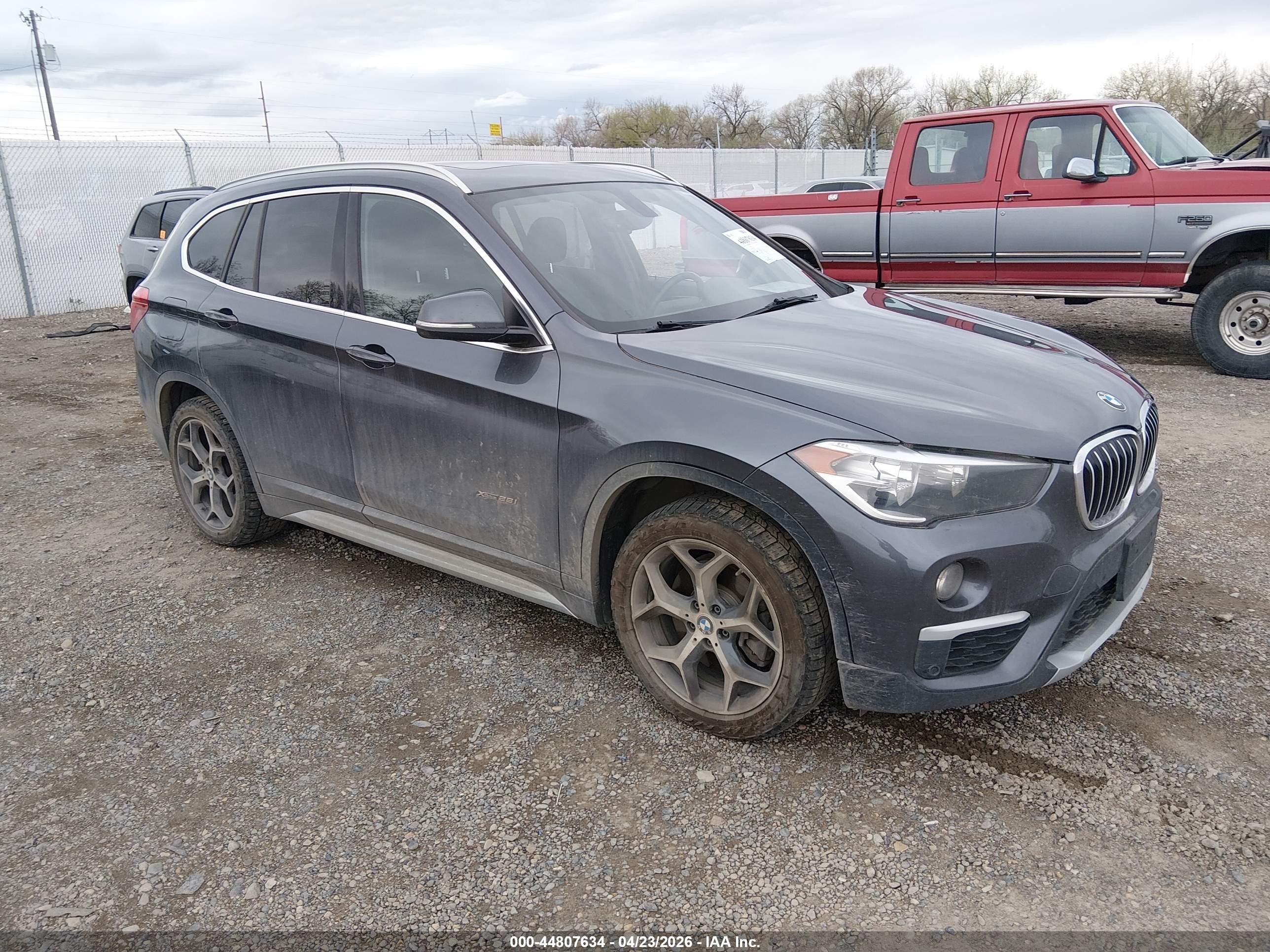 2018 BMW X1 xDrive28i, VIN WBXHT3Z39J4A65972 — Side