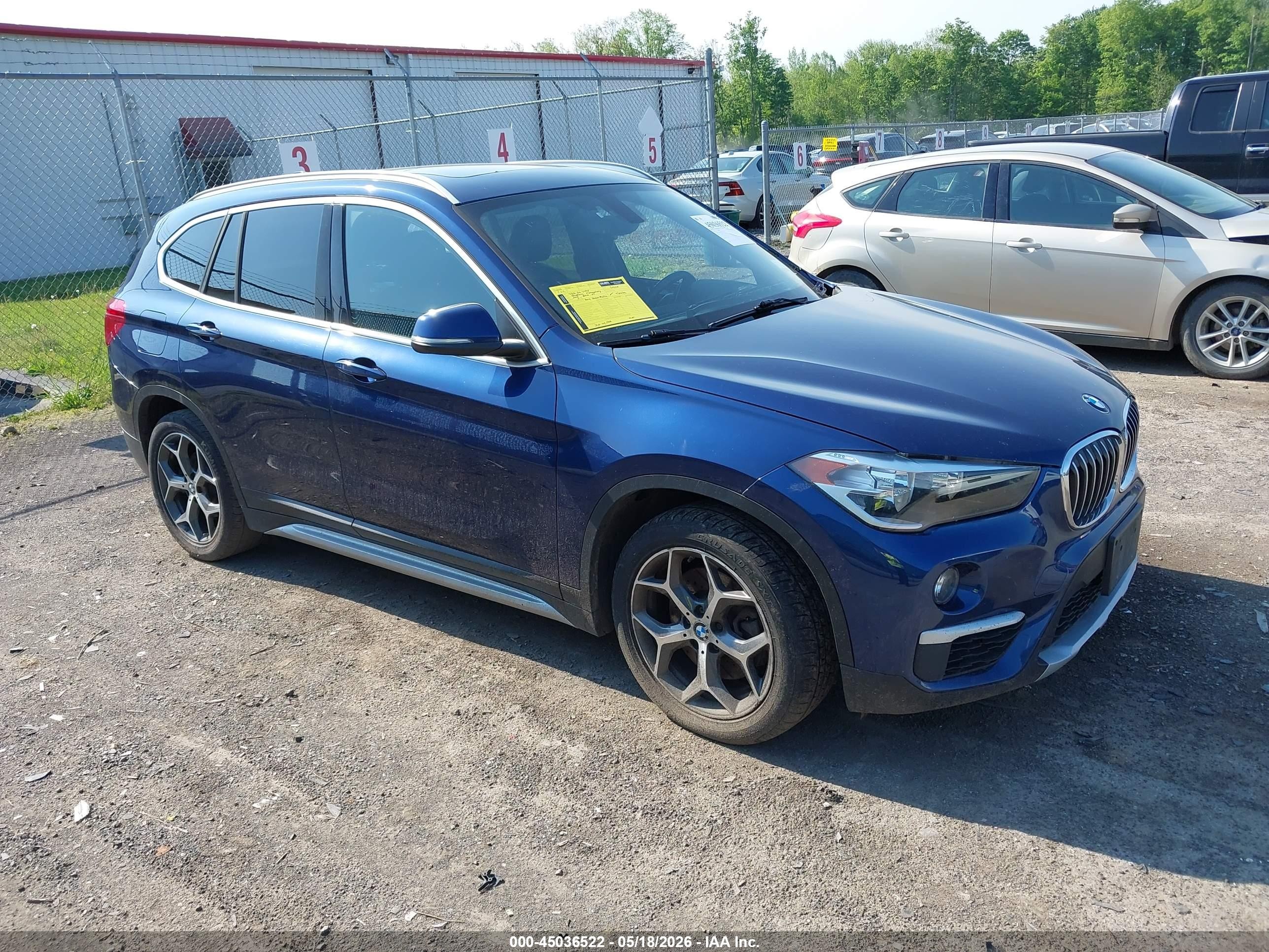 2018 BMW X1 xDrive28i, VIN WBXHT3C34J5L27977 — Side