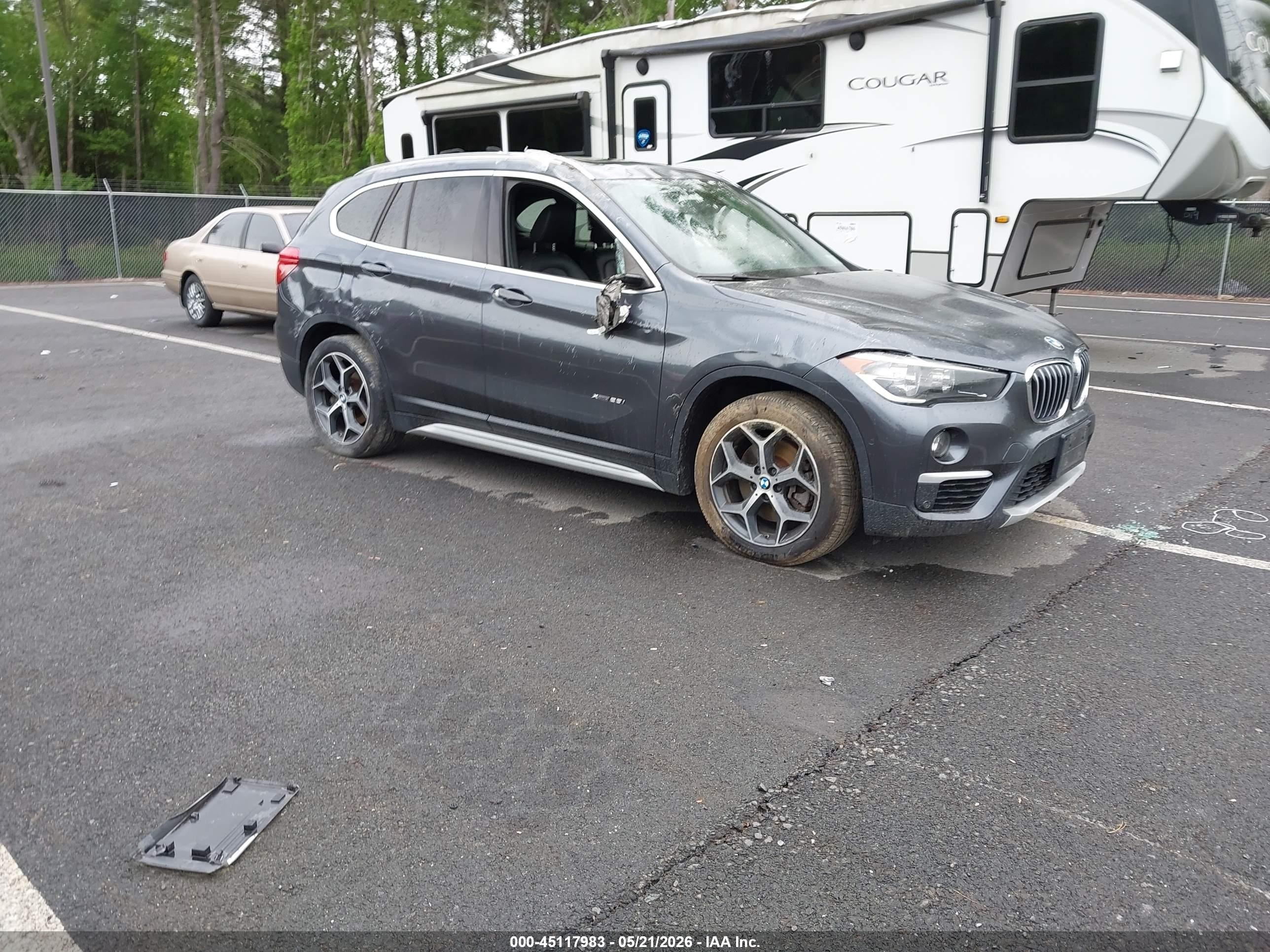 2018 BMW X1 xDrive28i, VIN WBXHT3C33J5K27627 — Side