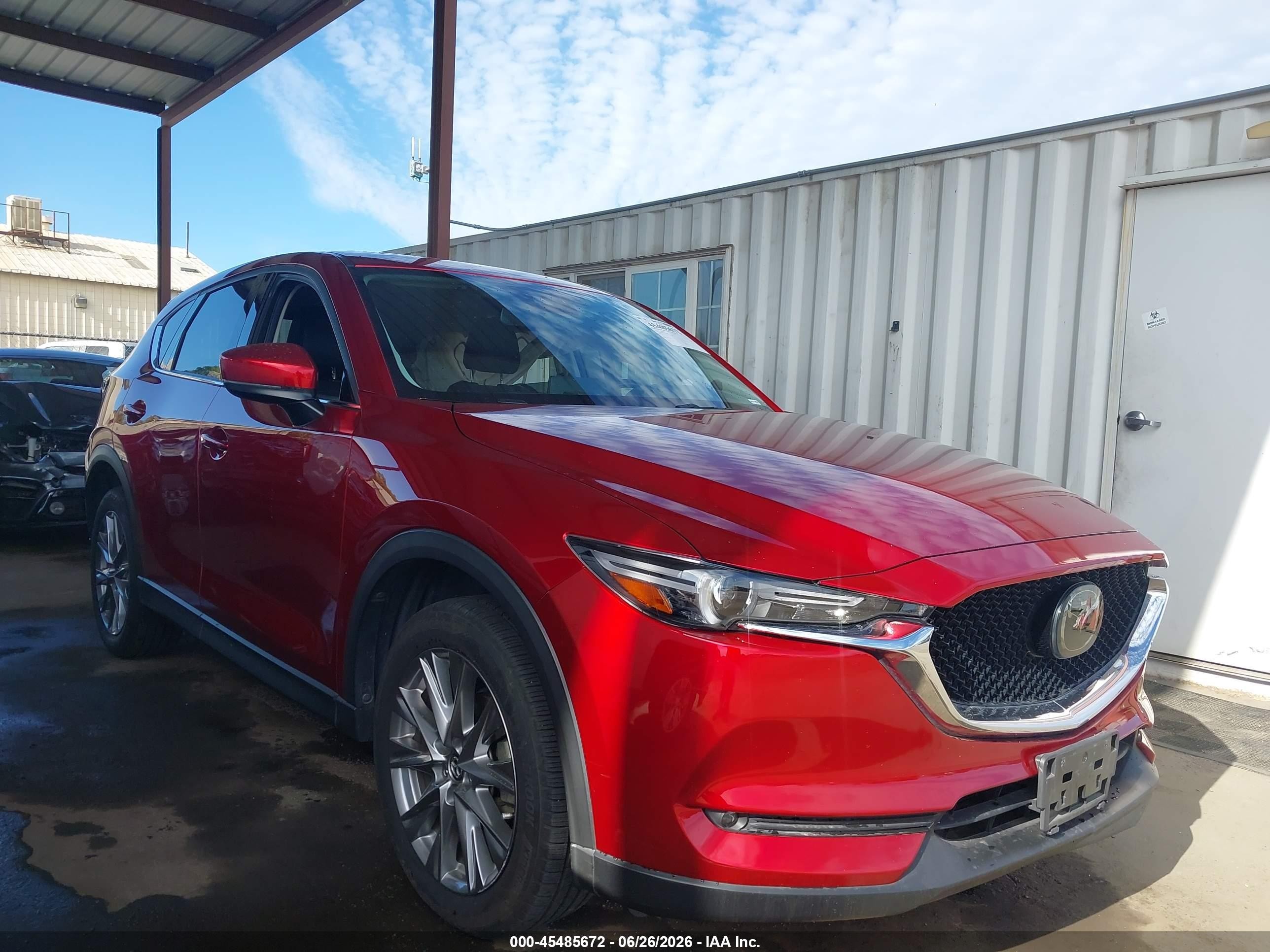 2021 Mazda CX-5 Grand Touring, VIN JM3KFBDM3M1384881 — Side