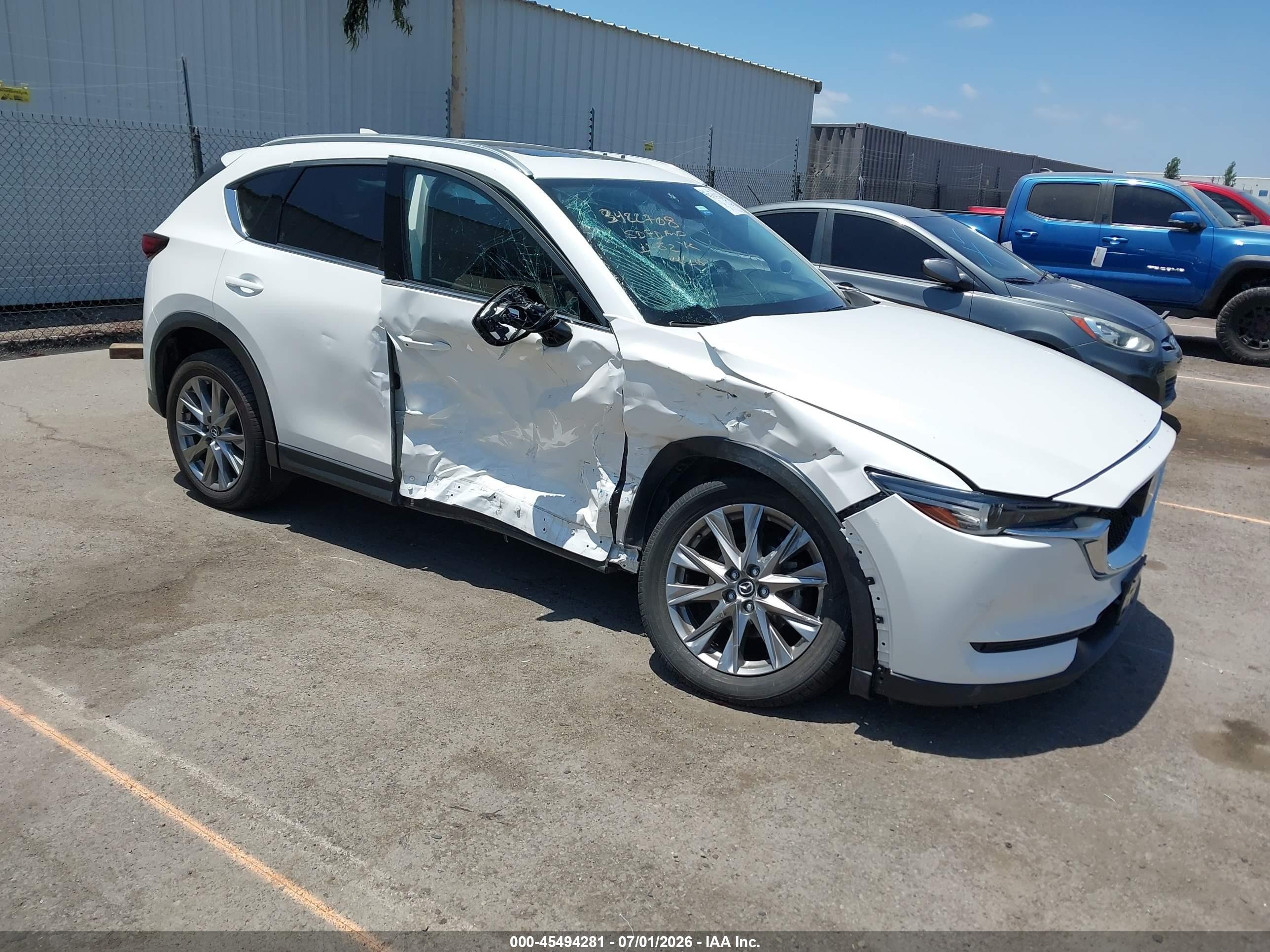 2021 Mazda CX-5 Grand Touring, VIN JM3KFADMXM1367568 — Side