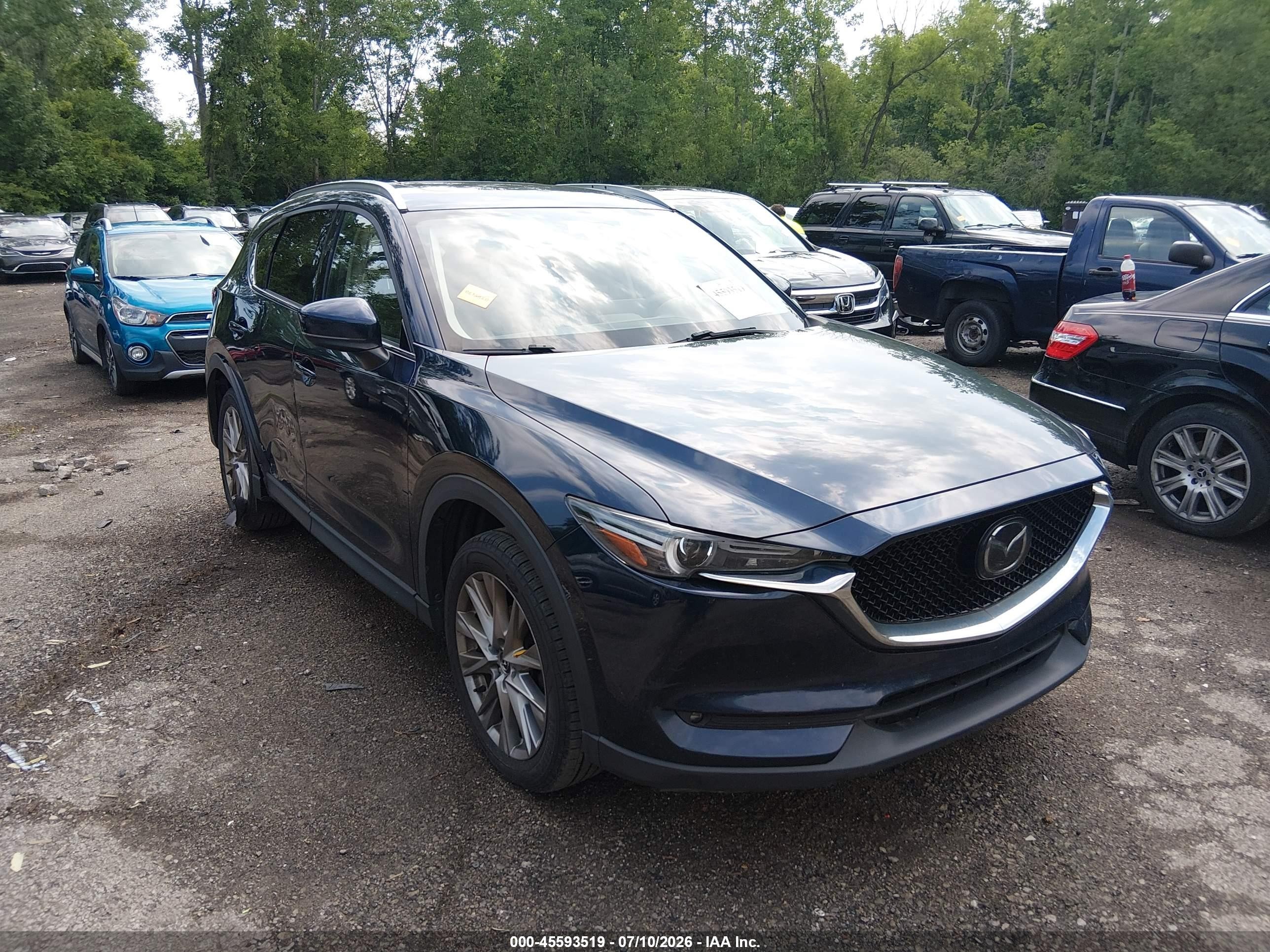 2021 Mazda CX-5 Grand Touring, VIN JM3KFBDM0M1437679 — Side