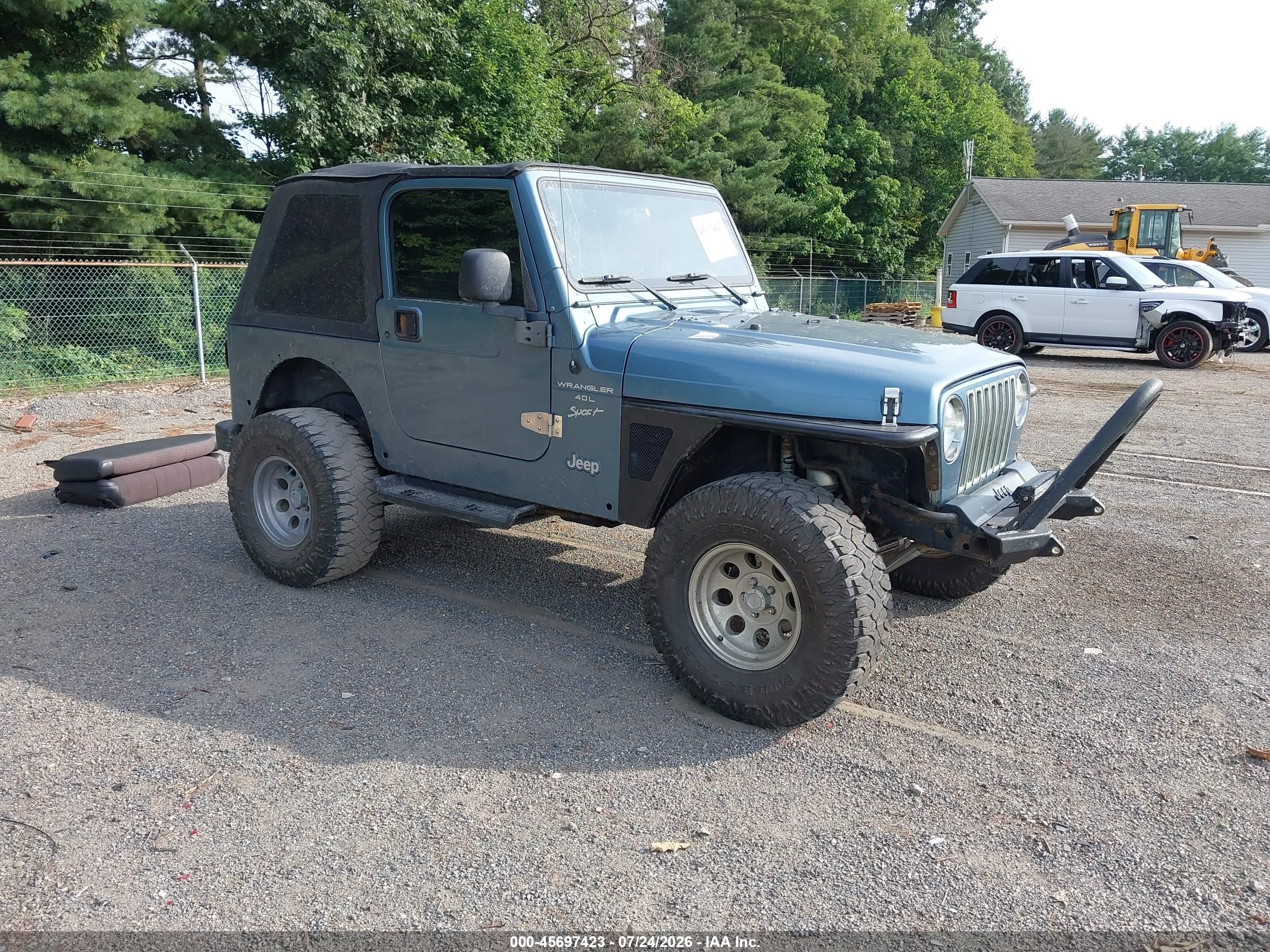 1999 Jeep Wrangler Sport, VIN 1J4FY19S7XP469370 — Side